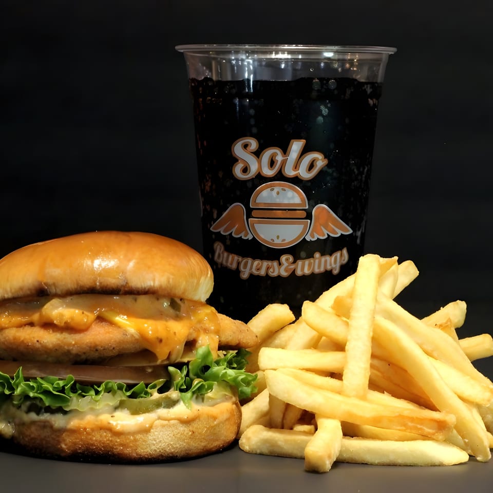 A Solo Burgers & Wings combo meal with a burger, fries, and a soda.